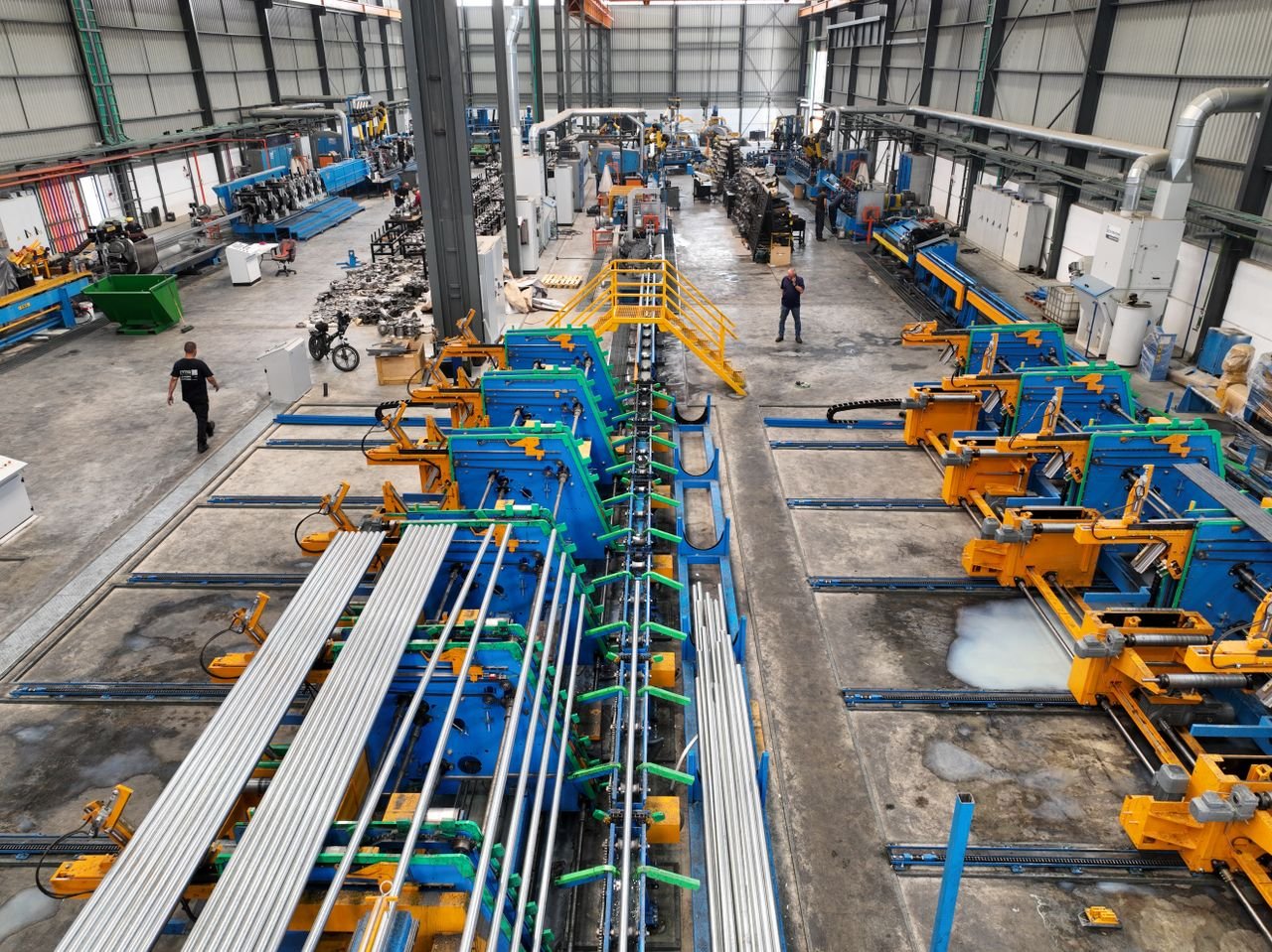 Overhead view of a busy manufacturing plant floor with workers and production lines